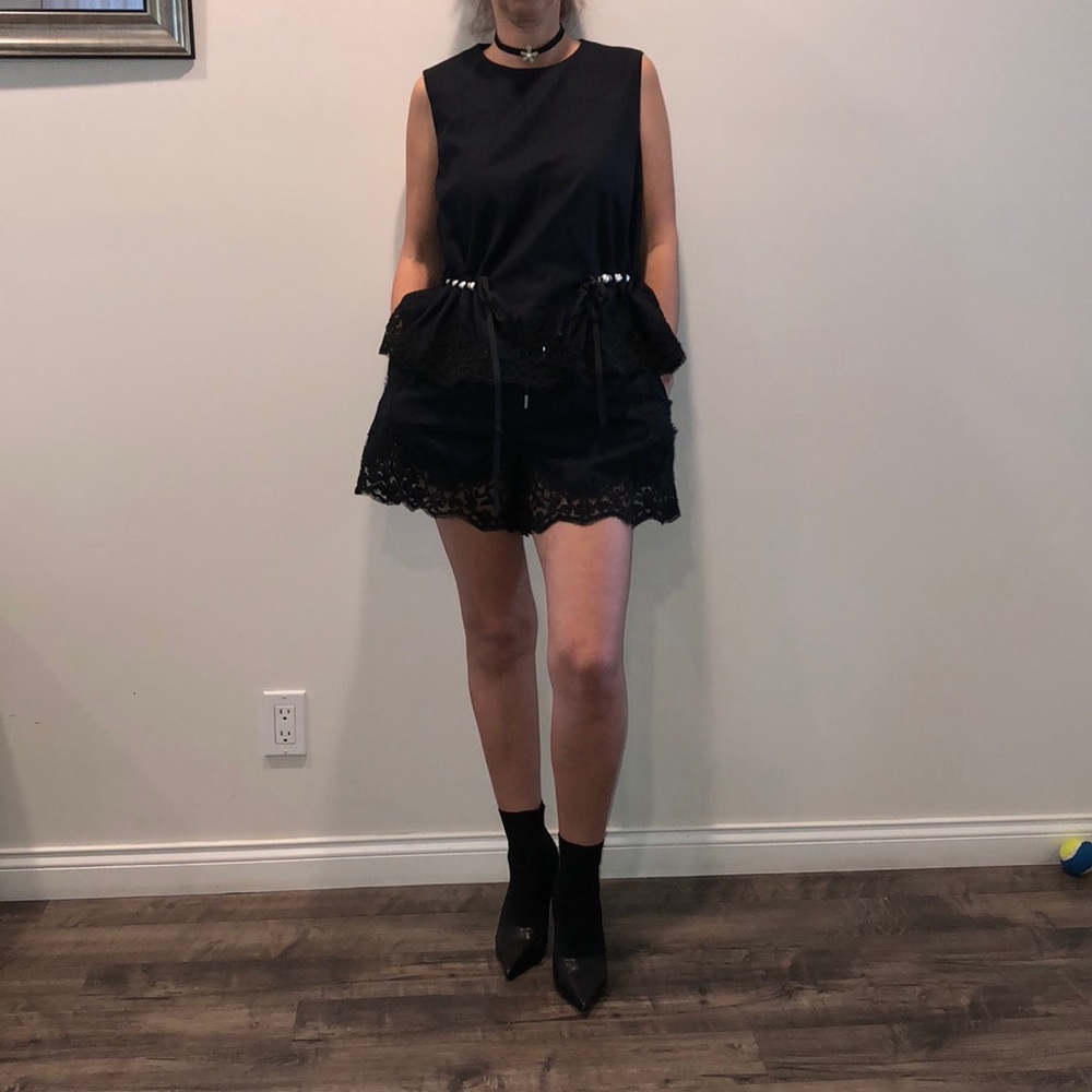 Black top and shorts with faux pearls and lace.